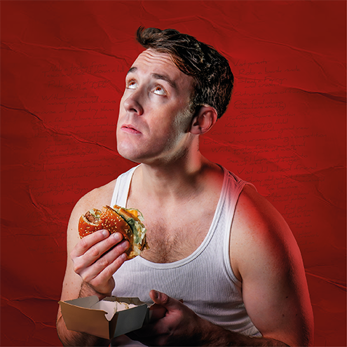 A man looks up forlornly holding a burger