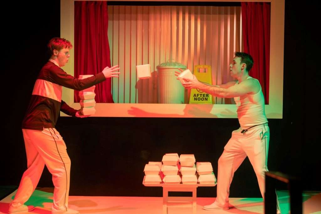 Oliver Maynard and Nick Hyde throw and catch burger boxes